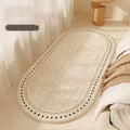 Descente de lit ovale crème Nesty - Vue en hauteur du motif éventail, plaid beige posé à côté
