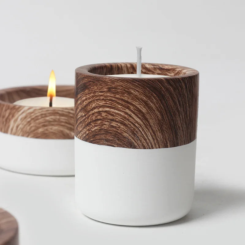 Coupe à bougie en céramique vide Nesty - Gros plan sur une coupe effet bois et blanc avec mèche, une bougie allumée floutée derrière