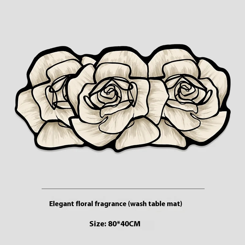 Tapis de salle de bain en forme de trois roses blanches à contour noir, détouré sur fond gris avec l'indication de taille 80x40 cm.