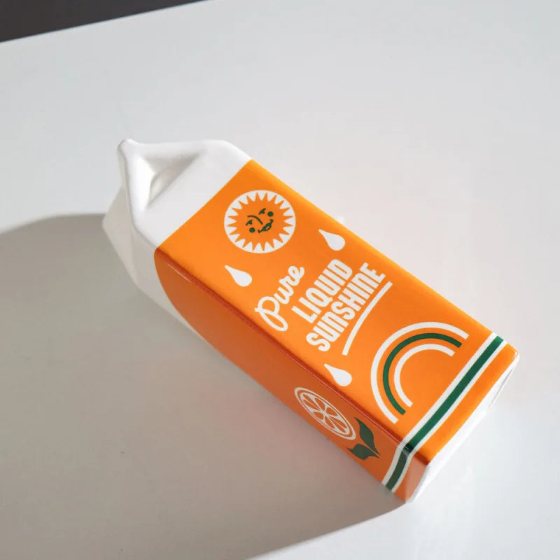 Vase en céramique forme fruit, orange décorative Nesty, vase couché sur le flanc, imprimé "Pure Liquid Sunshine", vu de dessus
