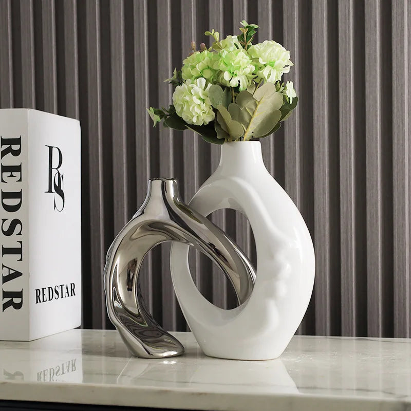 Vase en poterie Nesty - Coloris argenté et blanc avec hortensias verts, près d'une boîte 'Redstar'