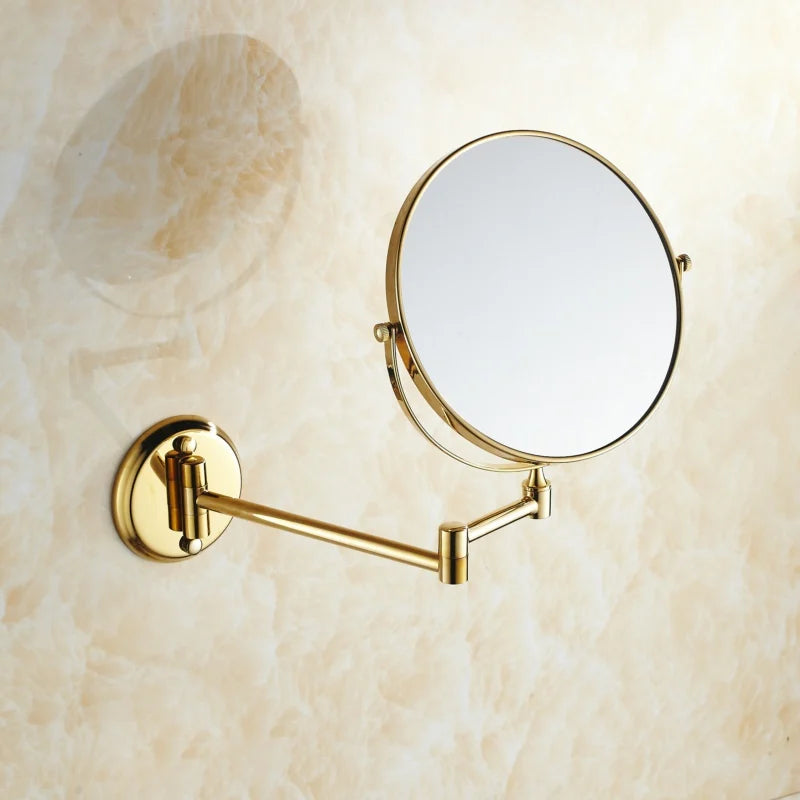 Miroir mural double face doré Nesty - Vue en angle sur fond marbré, bras articulé replié