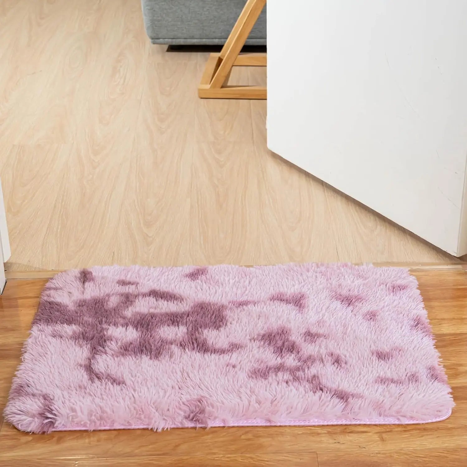 Tapis tie-dye antidérapant Nesty - Coloris rose et violet, devant une porte