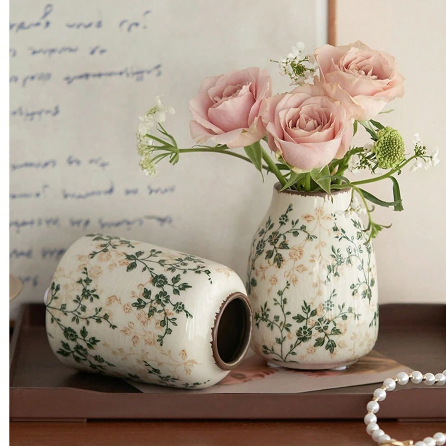 Vase en céramique craquelé, fait main, esprit bohème Nesty, deux vases craquelés à motif floral, l'un couché et l'autre garni de roses roses, sur plateau en bois avec collier de perles