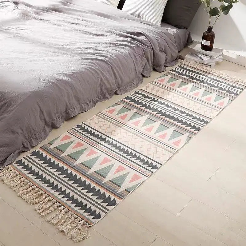 Tapis en coton et lin tissé main — motif berbère - Nesty, chemin de lit à franges motif triangles rose, vert et écru, posé au pied d'un lit