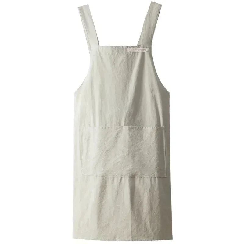 Tablier en lin uni vert clair, style japonais bretelles croisées avec grande poche, sur fond blanc - Nesty