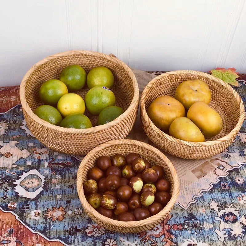 Corbeille tressée en rotin Nesty - Trois tailles utilisées comme coupes à fruits, agrumes, mangues et jujubes, sur tapis