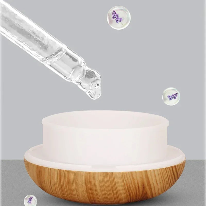Diffuseur d'huiles essentielles en bois Nesty - Pipette versant des gouttes de lavande dans le réservoir blanc