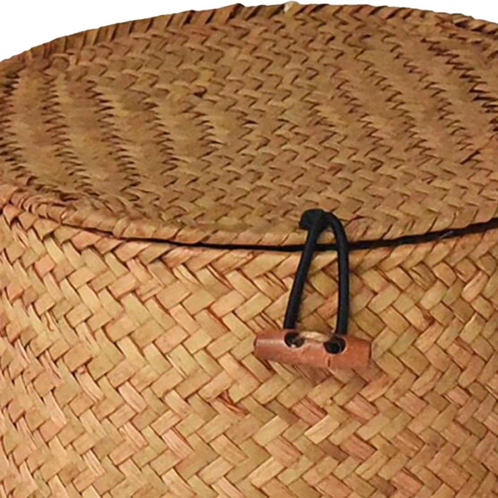 Panier rond en jonc de mer tressé avec couvercle, pour linge Nesty, gros plan sur le couvercle tressé avec cordon noir et fermoir en bois