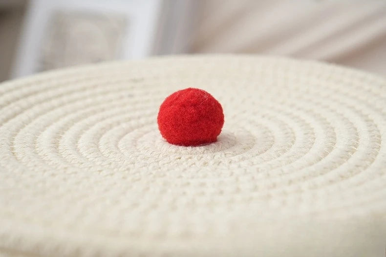 Panier de rangement pliable en corde de coton, grande capacité Nesty, gros plan sur le pompon rouge au centre du couvercle tressé
