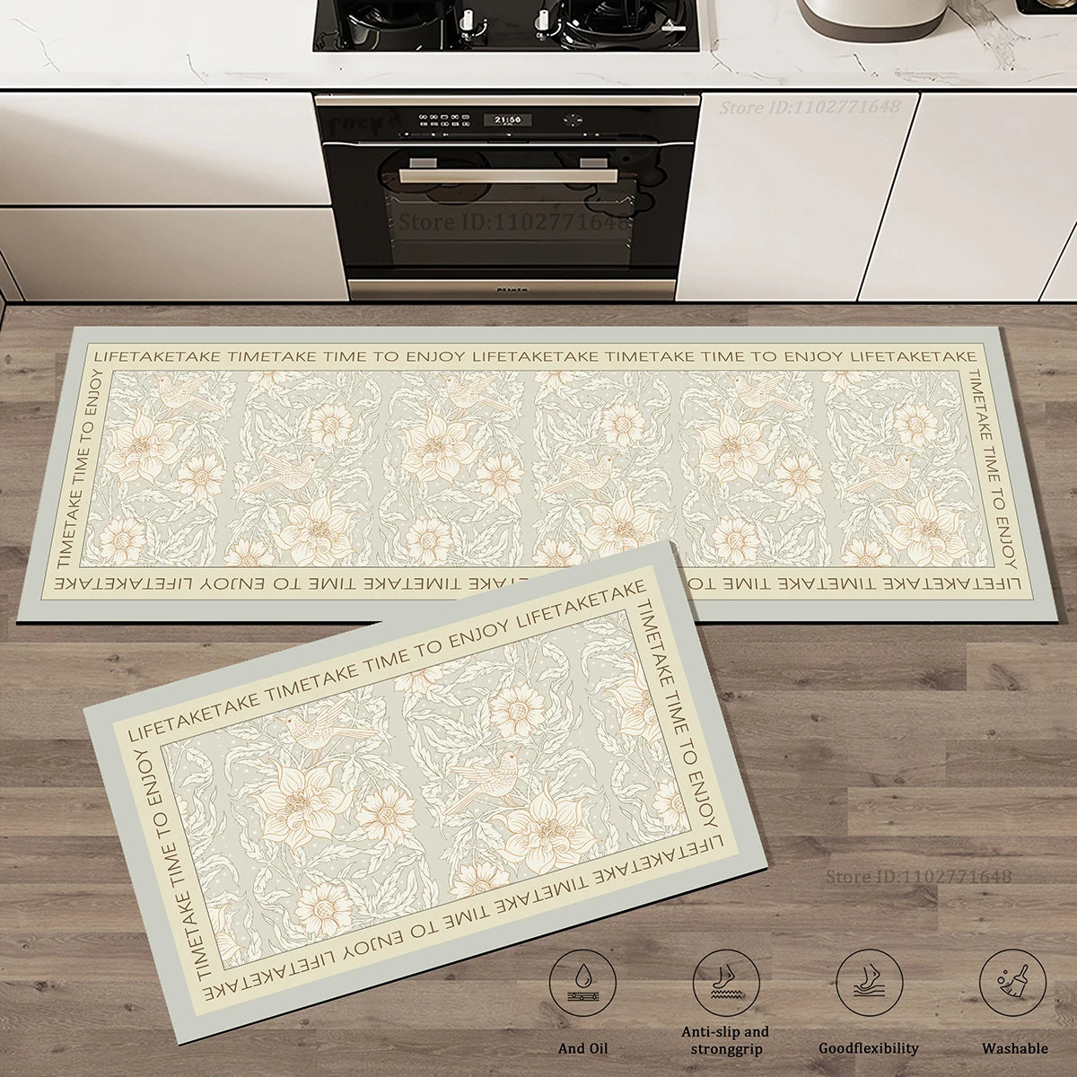 Set de deux tapis de cuisine à motif floral et d'oiseaux sur fond vert sauge avec bordure à inscription, posés devant une cuisinière.