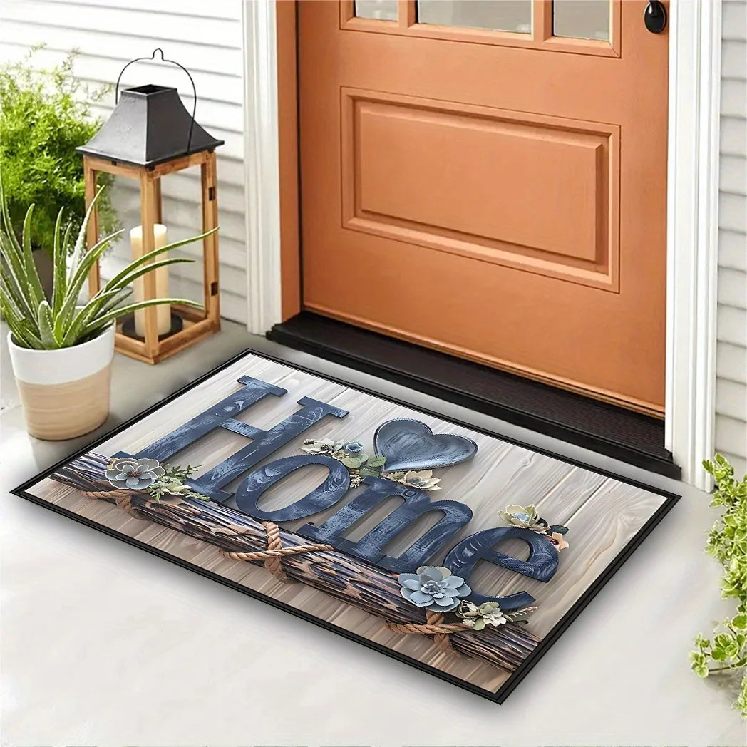 Paillasson imprimé 'Home' effet lettres bois et corde, avec cœur floral, devant une porte d'entrée orange et une lanterne - Nesty