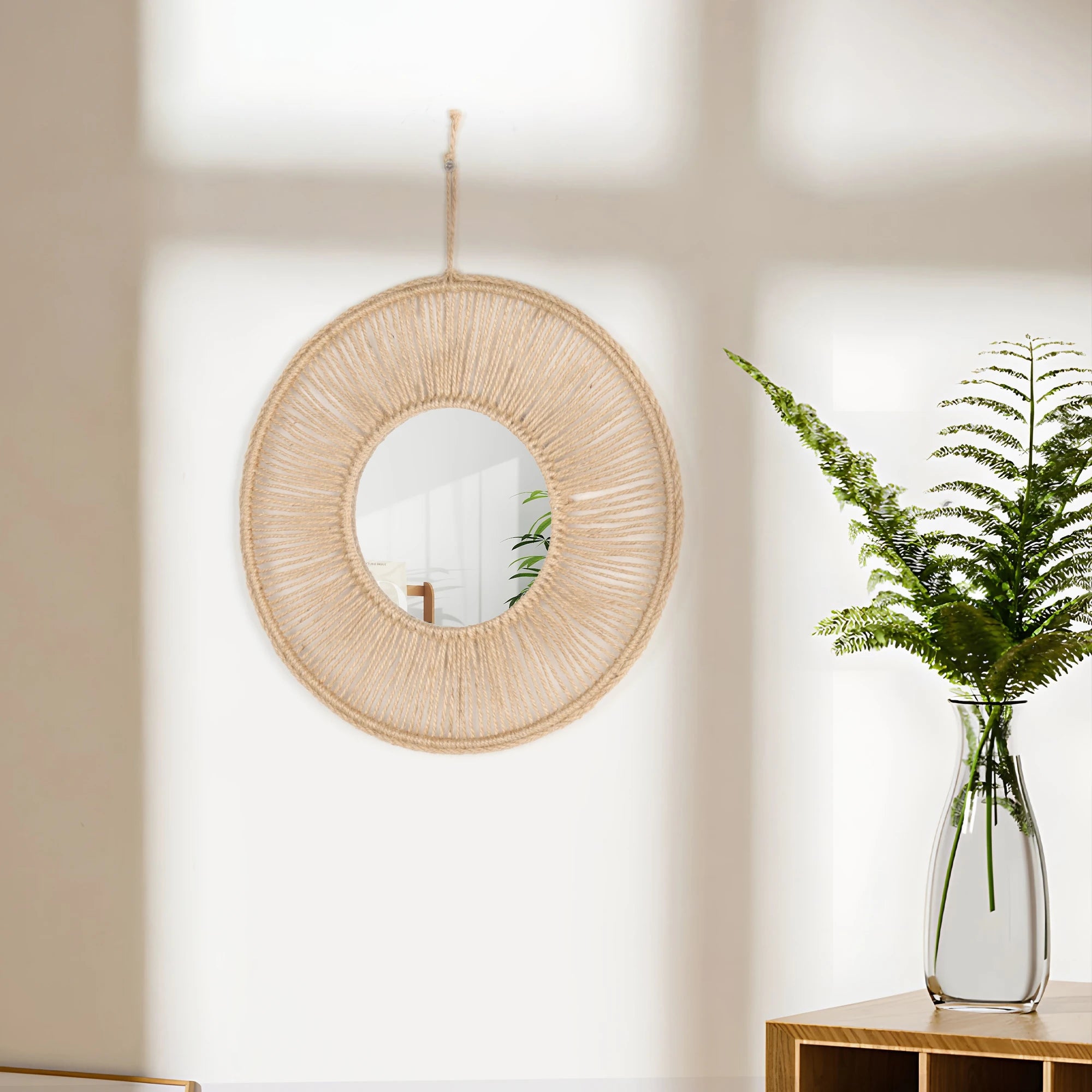 Miroir mural rond enroulé de corde de raphia naturel, suspendu près d'un vase en verre avec fougère - Nesty