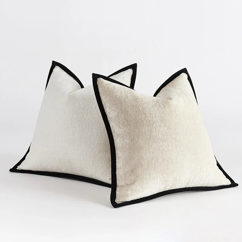 Housse de coussin en chénille épaisse, uni, bords piqués Nesty, deux housses de coussin en chénille écrue, bords surpiqués noirs, posées de biais sur fond blanc