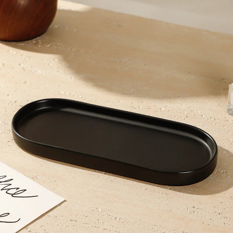 Diffuseur de parfum en céramique avec plateau Nesty - Plateau ovale noir seul, posé sur surface en pierre claire