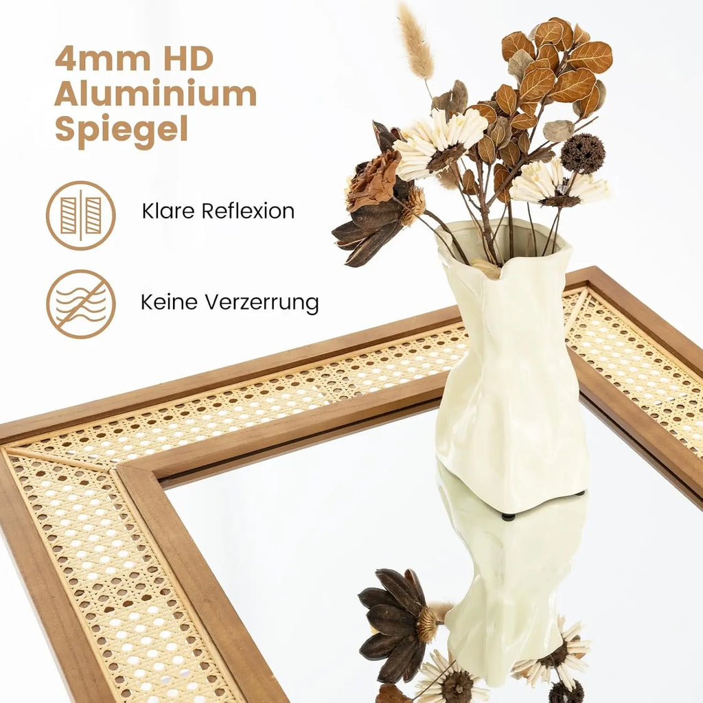 Miroir mural en rotin Nesty - Gros plan sur l'angle en cannage et un vase de fleurs séchées posé dessus (contenu en allemand)