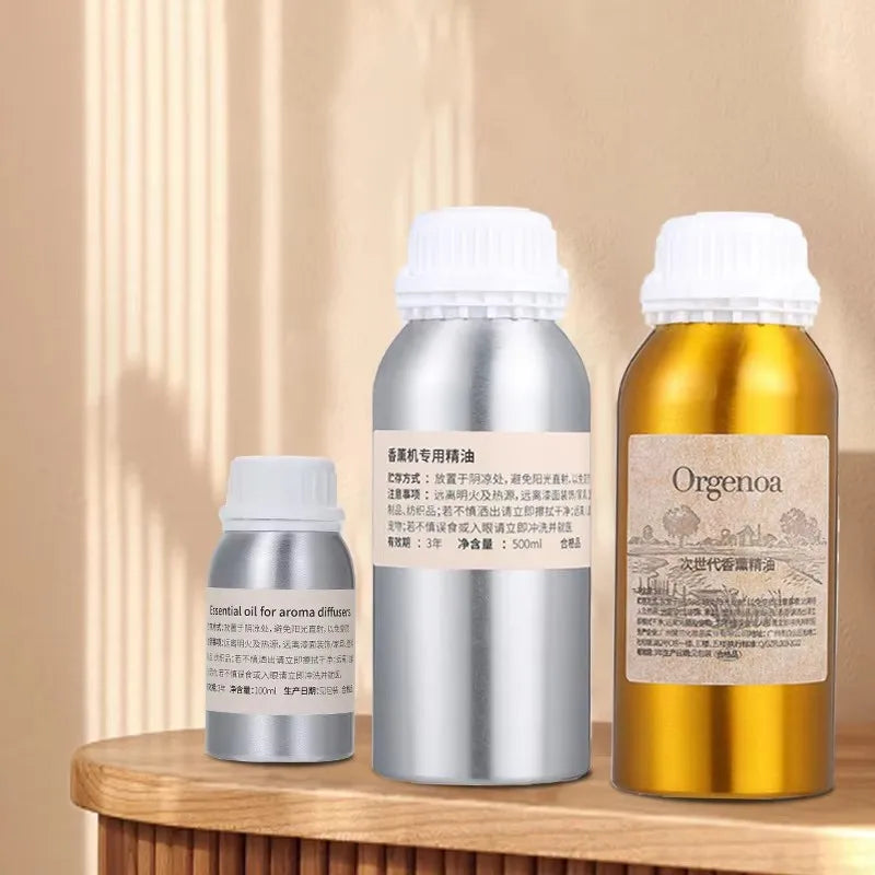 Recharge huile parfumée pour diffuseur Nesty - Trois flacons en aluminium argenté et doré, tailles 100 à 500 ml, sur console en bois