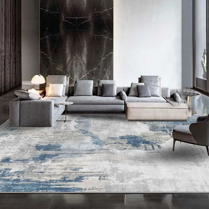 Tapis à motif géométrique sans peluches pour salon Nesty - Coloris gris et bleu abstrait façon béton dans un grand salon moderne