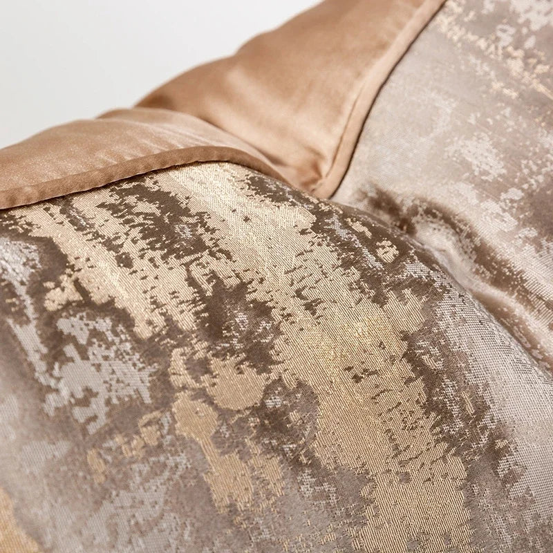 Housse de coussin jacquard, plusieurs formats et coloris Nesty, gros plan sur le tissu jacquard motif abstrait doré et taupe et la bordure beige piquée