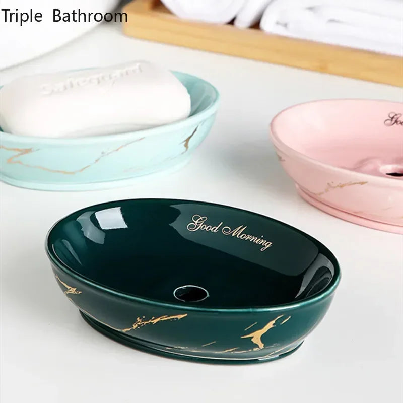 Porte-savon en céramique effet marbré, forme ronde Nesty, trois coloris vert, rose et turquoise effet marbré doré, le vert garni d'un savon, au premier plan