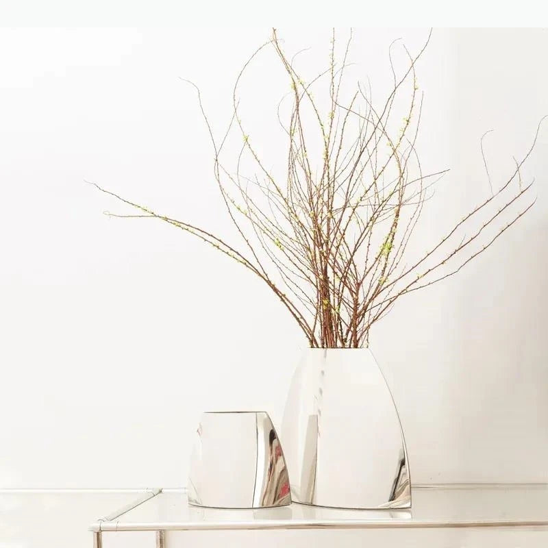 Vase arc en métal argenté — silhouette minimaliste - Nesty - Deux tailles avec branches de saule fleuries, sur console miroir