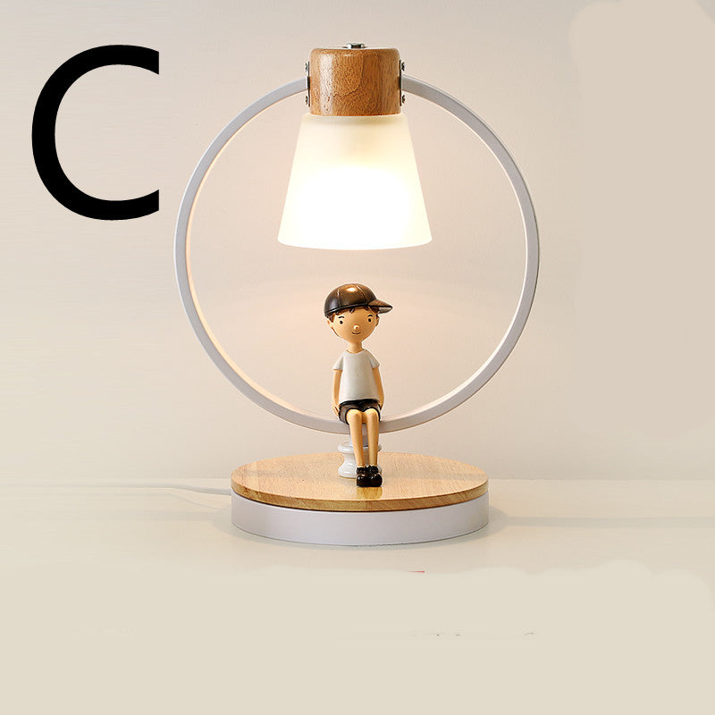 Lampe de chevet en bois massif Nesty - Modèle C, figurine garçon assis dans un anneau blanc